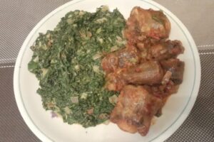 Coconut-creamed cowpeas leaves with oxtail